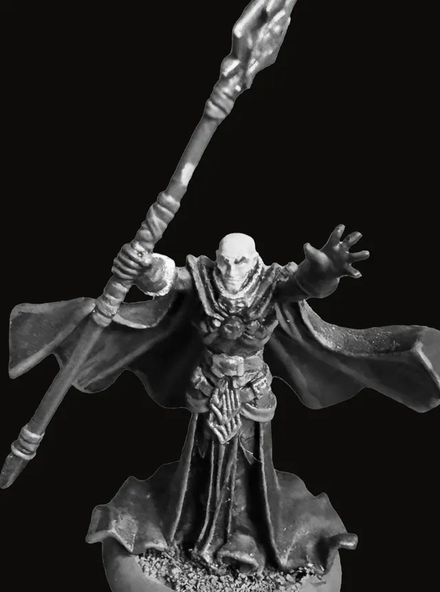 An unpainted pewter miniature of Eloryn Vale — a hooded, robed figure with arms outstretched, holding a long ornate staff crowned by a pointed crystal, heavy flowing robes curled at the hem, standing on a round base